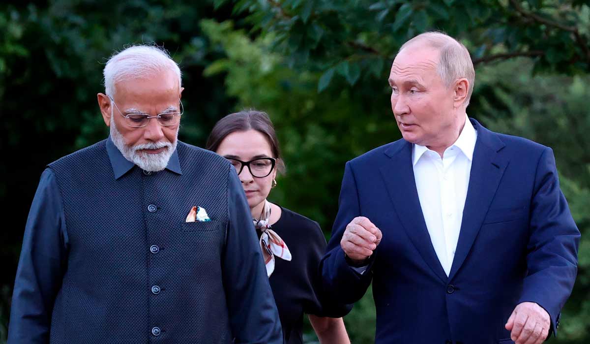 Prime Minister Narendra Modi, left, and Russian President Vladimir Putin walk during an informal meeting at Novo-Ogaryovo residence, outside Moscow | AP