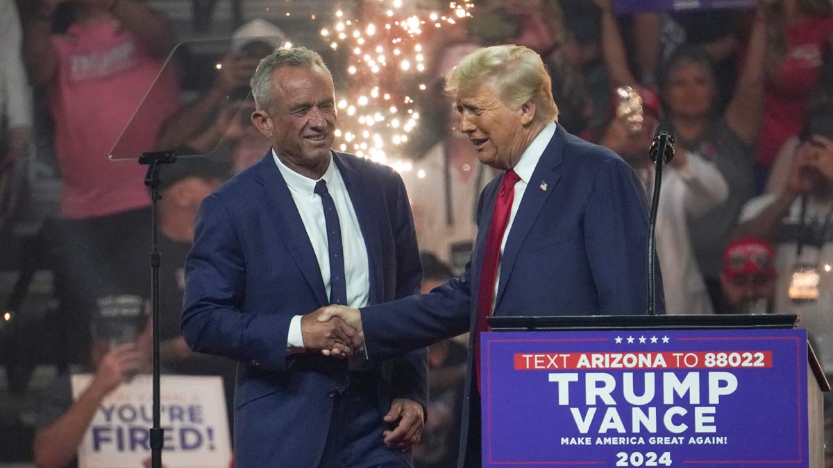 Republican presidential nominee and former US president Donald Trump shakes hands with former independent presidential candidate Robert F. Kennedy Jr. during a rally in Glendale, Arizona | Reuters