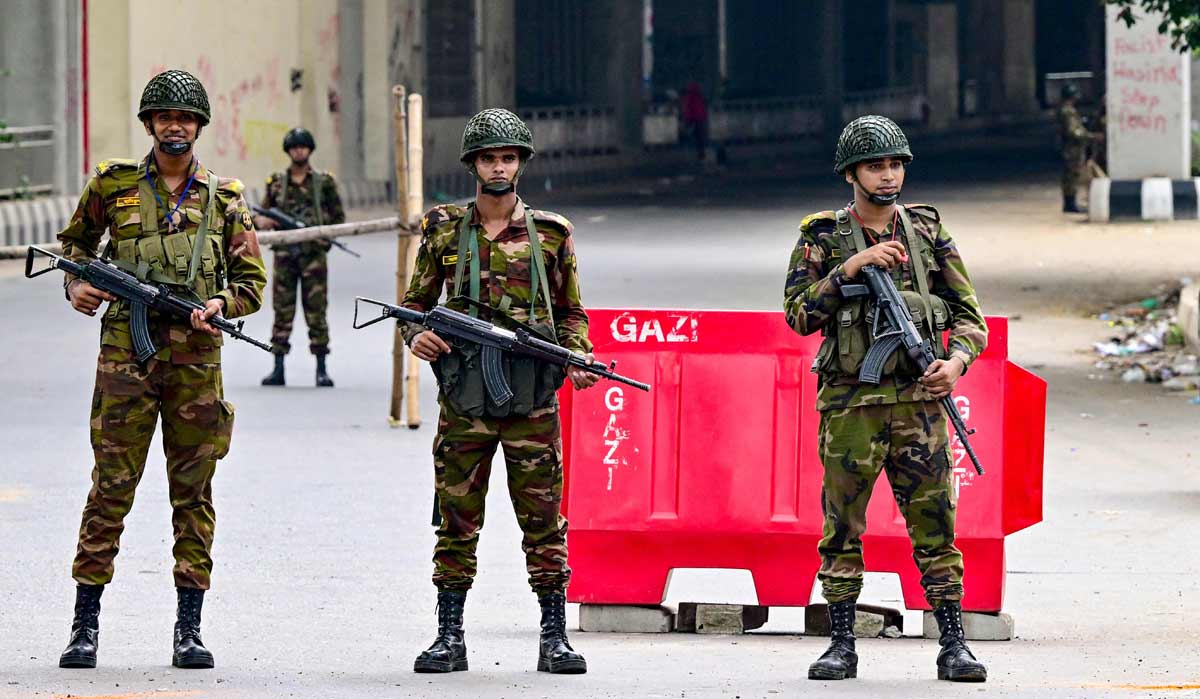 Bangladesh army personnel stand guard during a curfew following clashes between police and Anti-Discrimination Student Movement activists amid anti-government protests in Shahbagarea of Dhaka | AFP