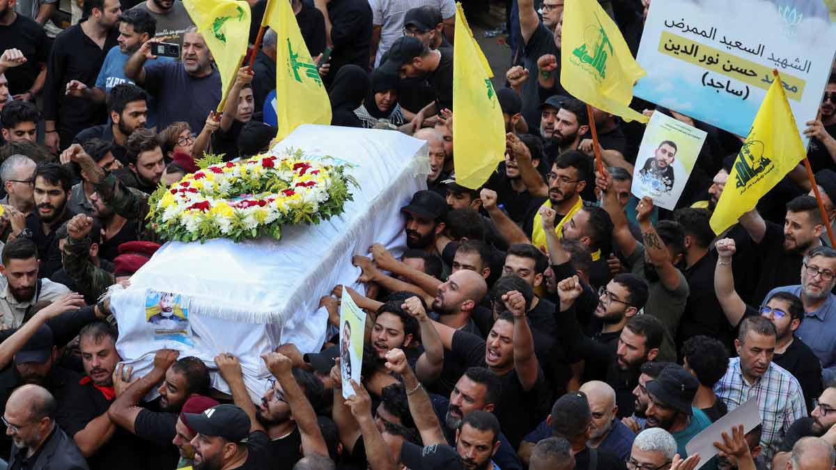 People carry the coffin of Mohamed Hassan Nour al-Din, who was killed amid the detonation of pagers across Lebanon, during his funeral in Beirut | Reuters