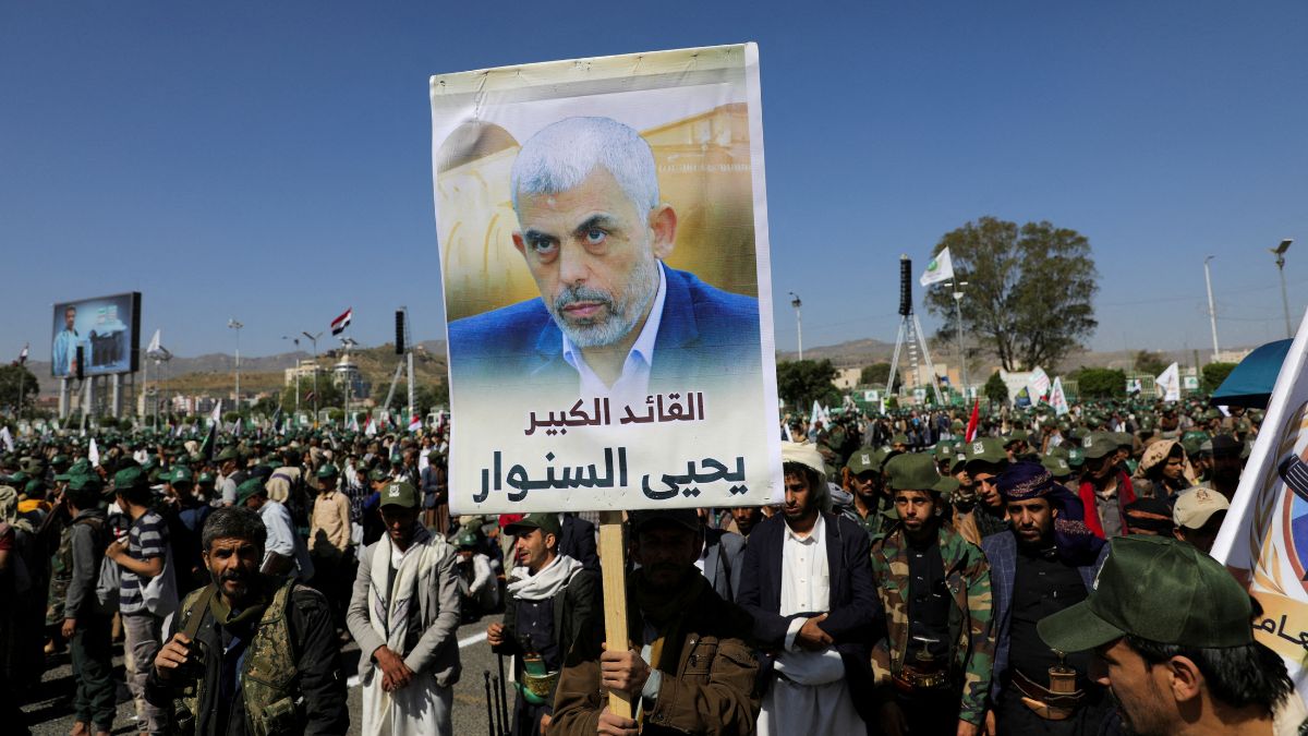A Houthi-mobilized fighter holds up a poster of Hamas leader, Yahya Singer, during a ceremony marking the 10th anniversary of the Houthi takeover in Sanaa, Yemen, on September 21, 2024 | Reuters