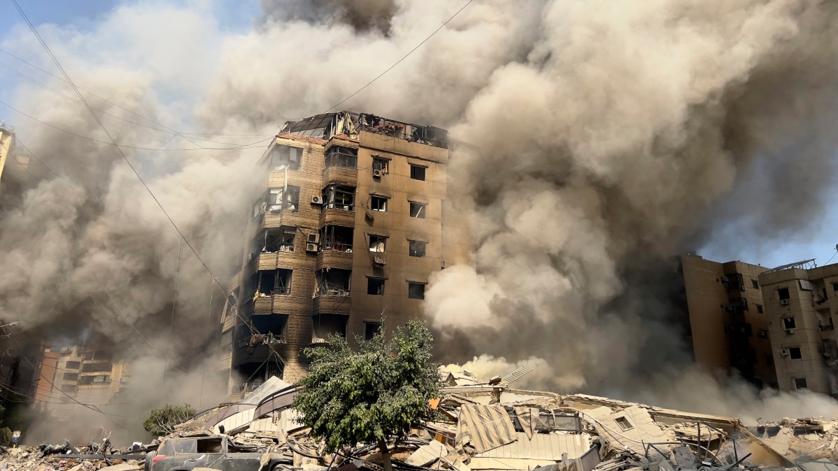 Smoke rises as a building collapses in Beirut's southern suburbs following Israeli attack | AP