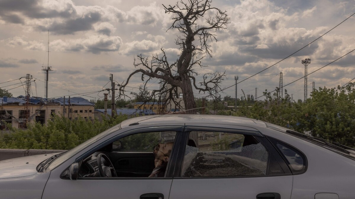 he body of a dead man is seen inside a car following shelling in Pokrovsk, eastern Donetsk region | AFP