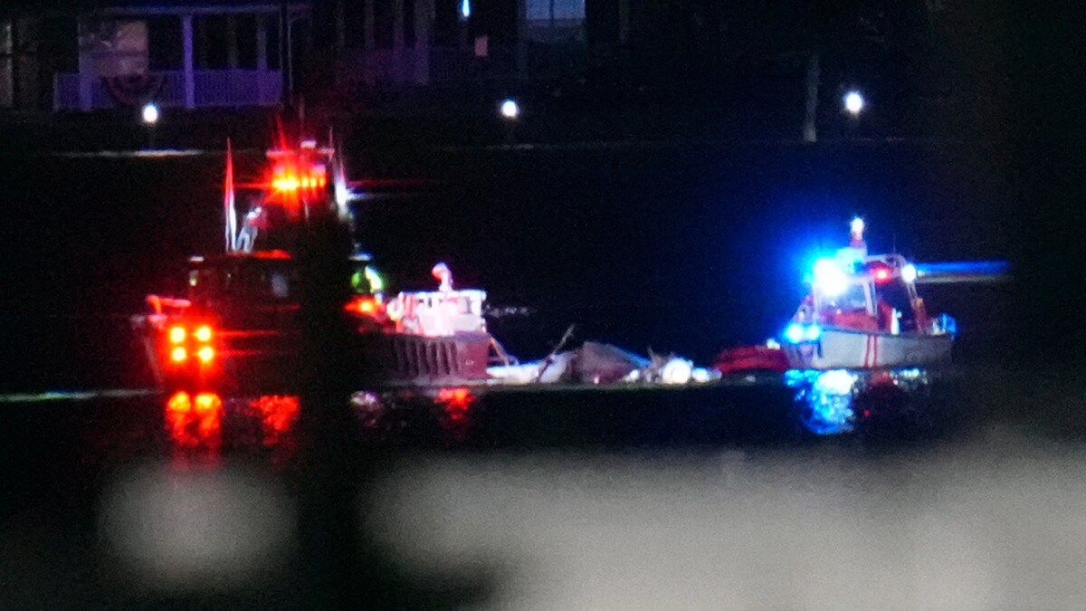 Boats work the scene on the Potomac River near Ronald Reagan Washington National Airport | AP