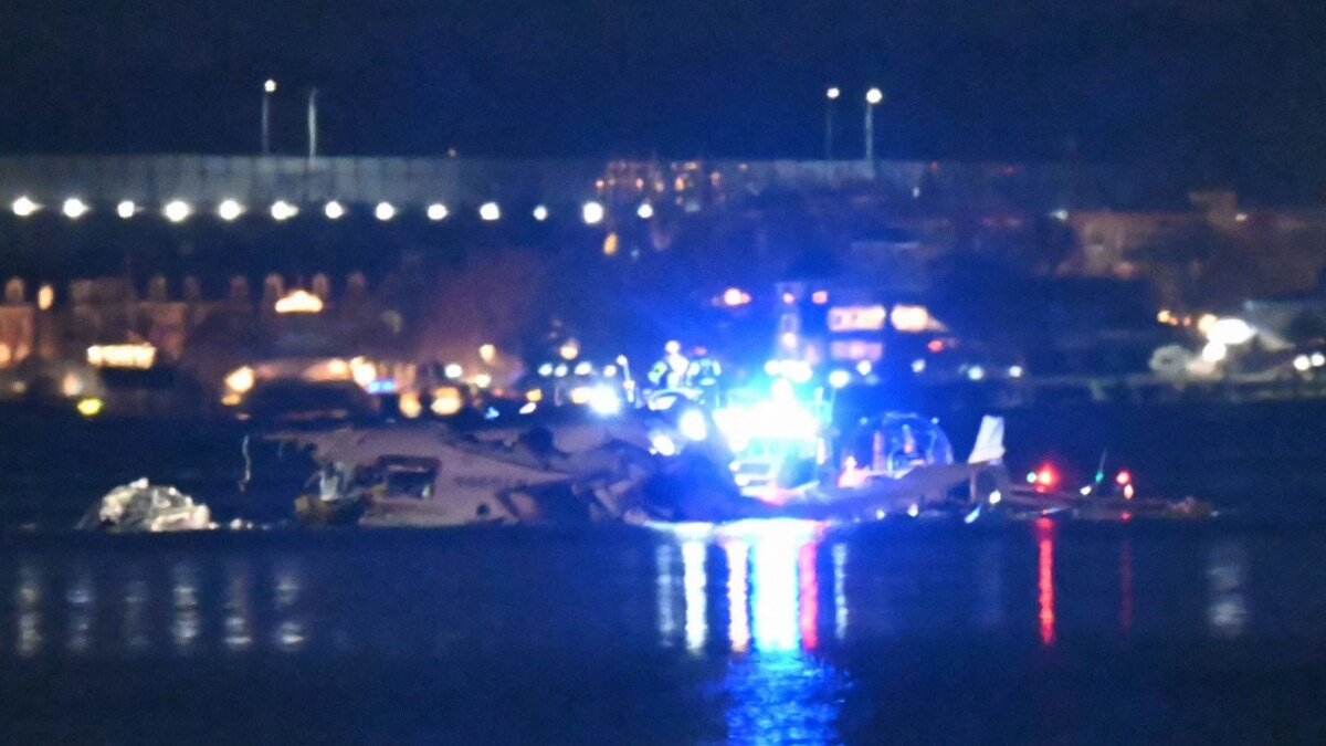 Part of the wreckage is seen as rescue boats search the waters of the Potomac River | AFP