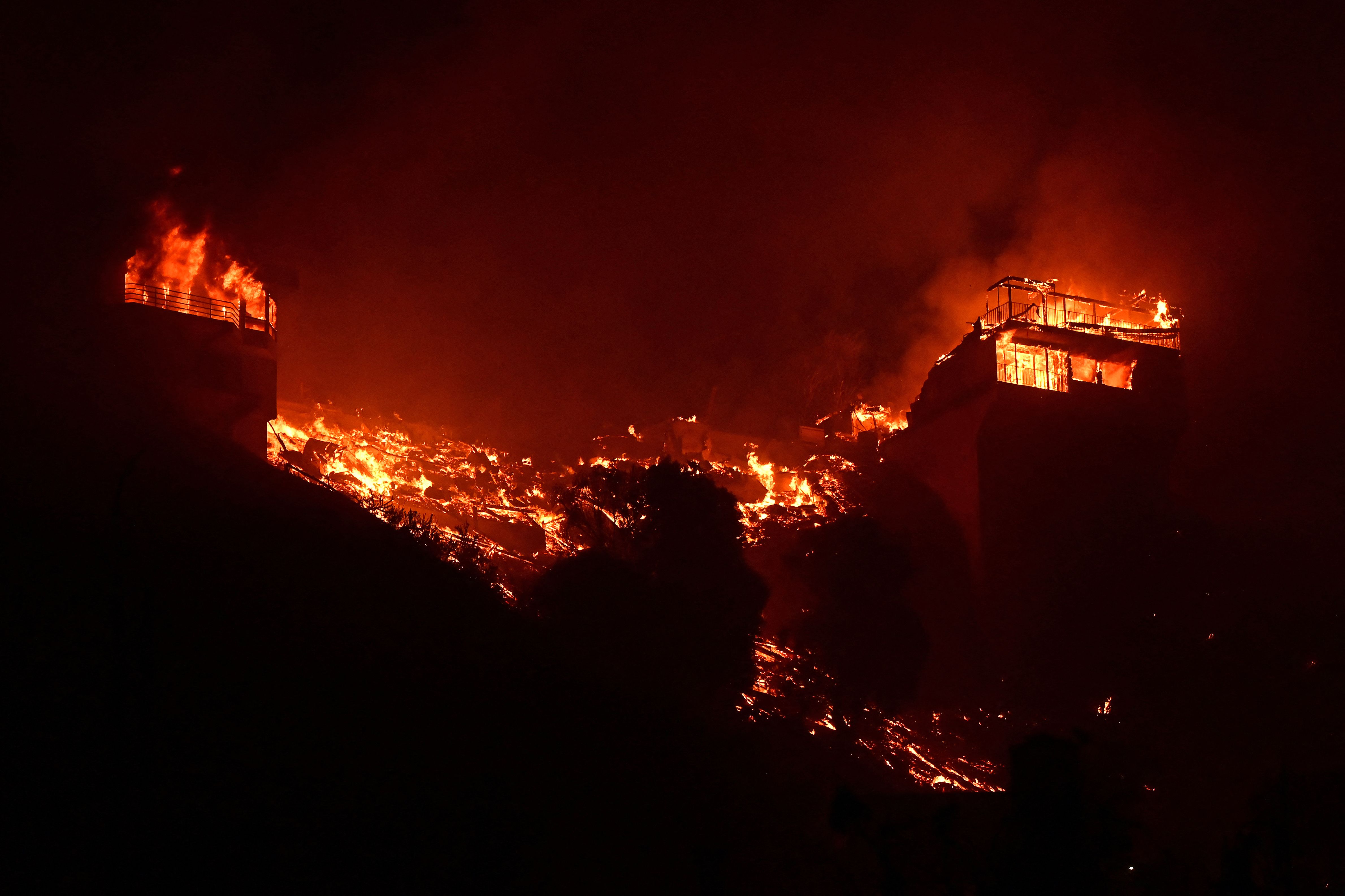Structures burn along Pacific Coast Highway during the Palisades Fire in Malibu | AFP