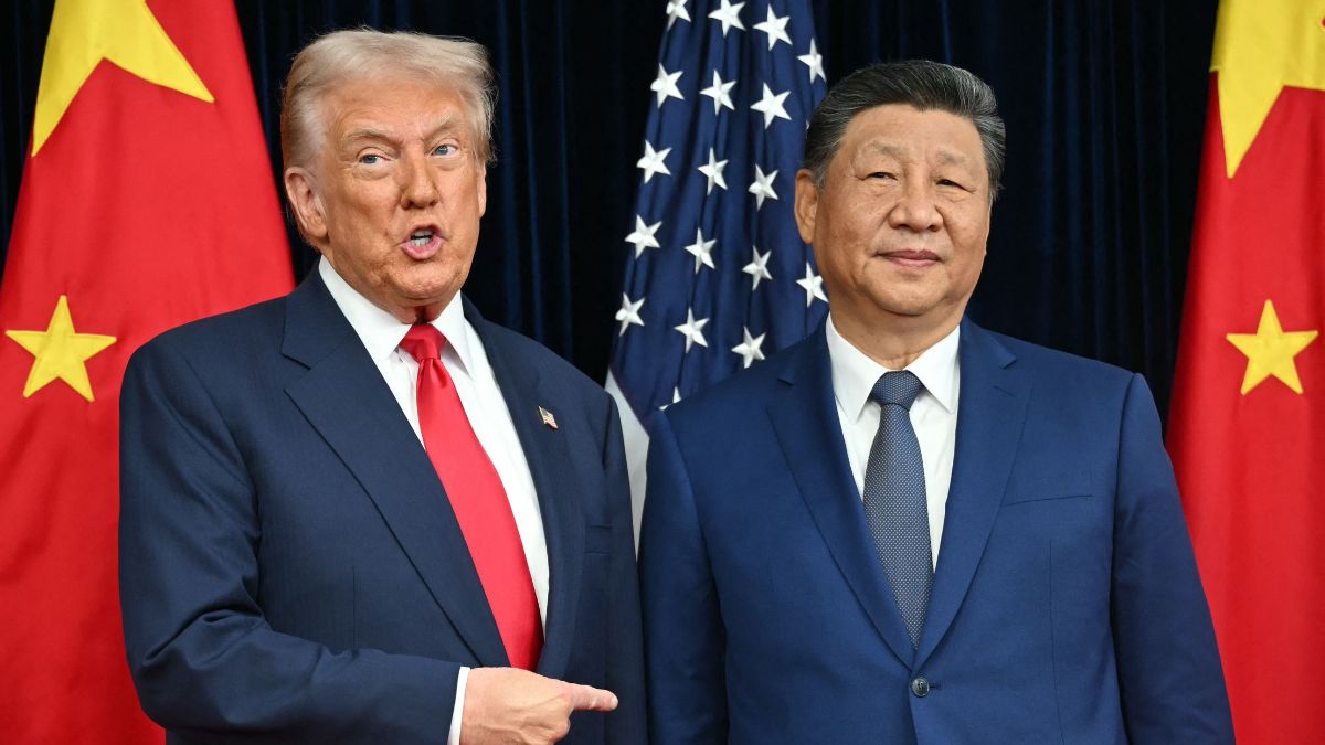 US President Donald Trump (L) and China's President Xi Jinping greet each other as they arrive for talks at the Gimhae Air Base, located next to the Gimhae International Airport in Busan | AFP 