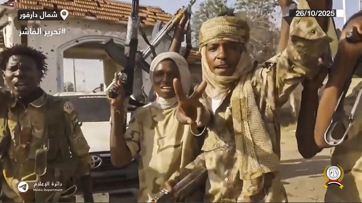 RSF fighters holding weapons and celebrating in the streets of El-Fasher in Sudan's Darfur. 