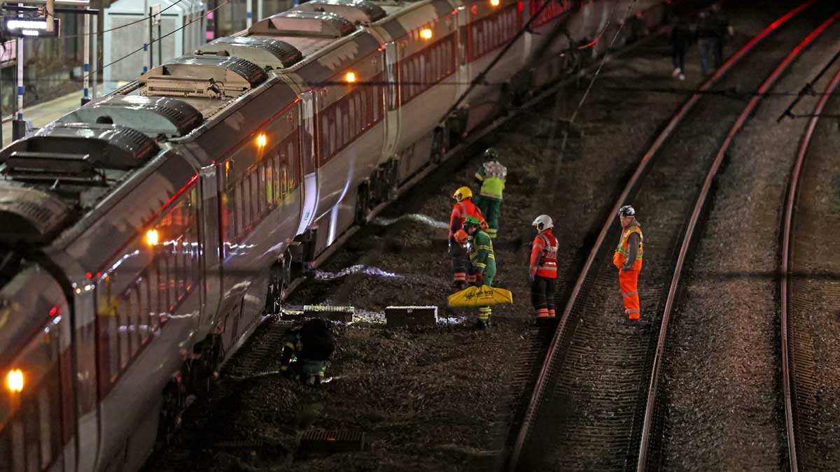 Emergency personnel inspect the train at the Huntingdon station in Cambridgeshire after several people were stabbed | AP