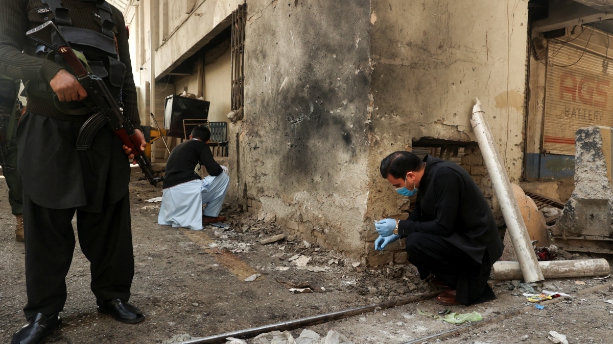 Members of the forensic team collect evidence from a site after suicide bombers targeted the headquarters of a Pakistani paramilitary force in Peshawar | Reuters