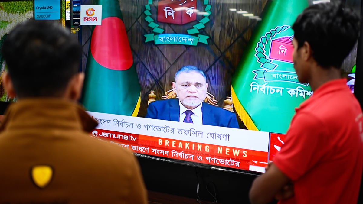 People watch Bangladesh's Chief Election Commissioner A.M.M. Nasir Uddin's address to the nation on a television, in Dhaka, Bangladesh, Thursday, Dec. 11, 2025. (AP Photo/Mahmud Hossain Opu)