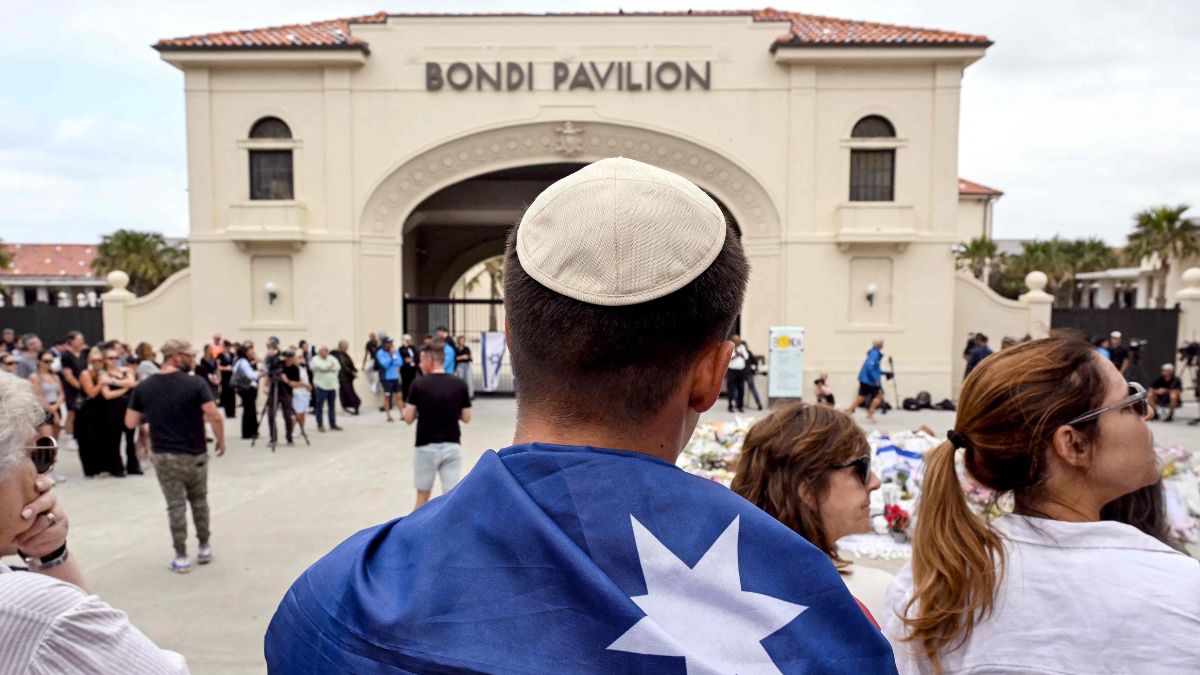 Mourners gather to pay a floral tribute to Bondi Beach shooting victims at the Bondi Pavilion in Sydney on December 15, 2025 | AFP