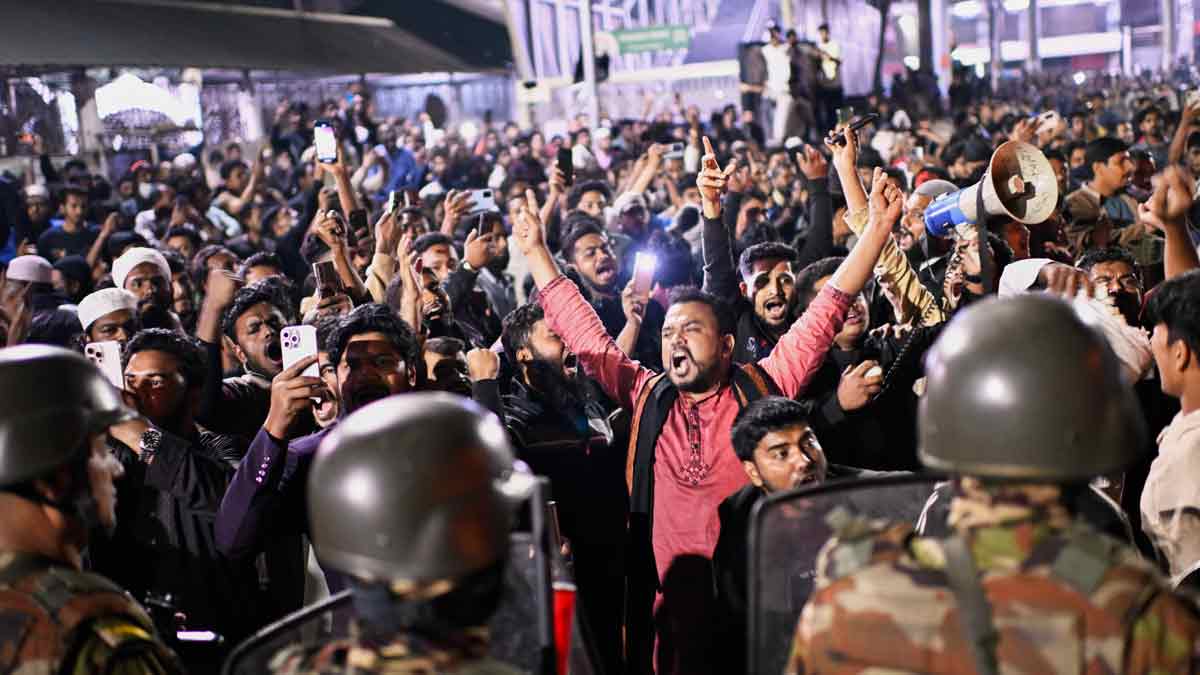 Protesters shout slogans in front of the premises of the Prothom Alo daily newspaper after news of Sharif Osman Hadi’s death, in Dhaka, Bangladesh | AP