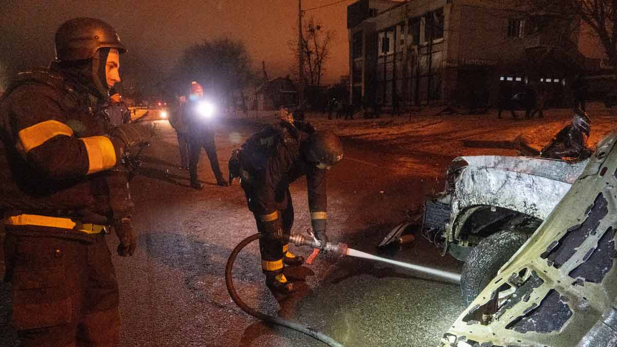 Firefighters put out the fire on the damaged vehicle hit by Russian airstrike in Kharkiv | AP
