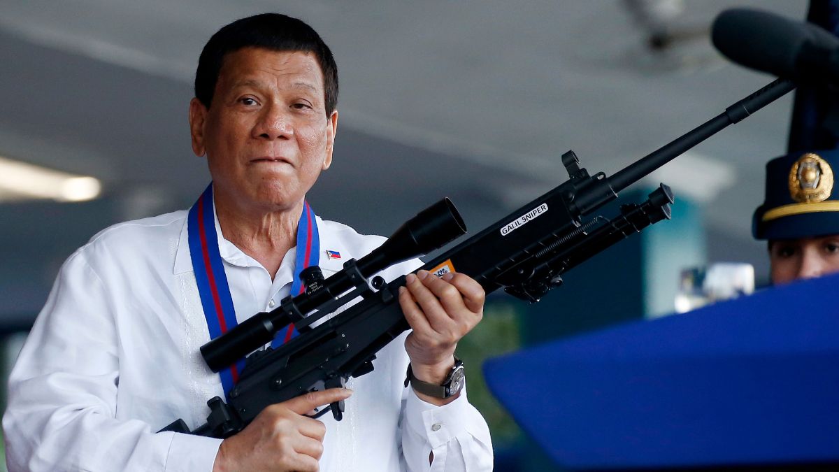 A file image of Philippine former President Rodrigo Duterte holding an Israeli-made Galil rifle in Manila | AP 