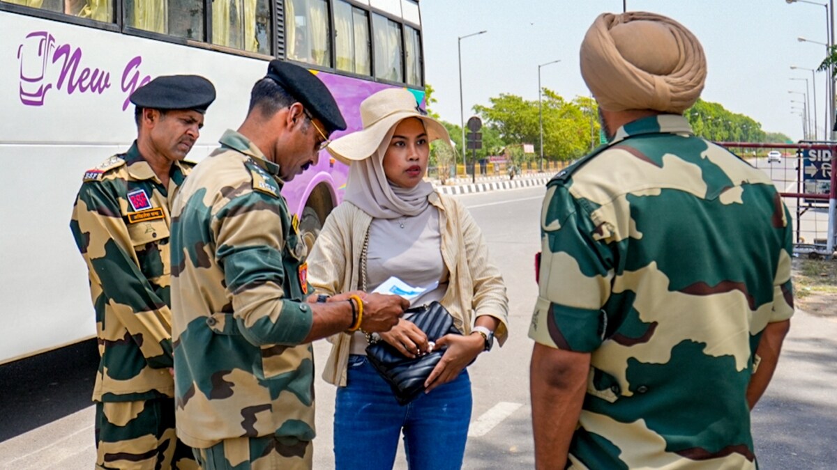 A foreign tourist being stopped from crossing the border at an Integrated Check Post, near the Attari-Wagah border in Amritsar | PTI