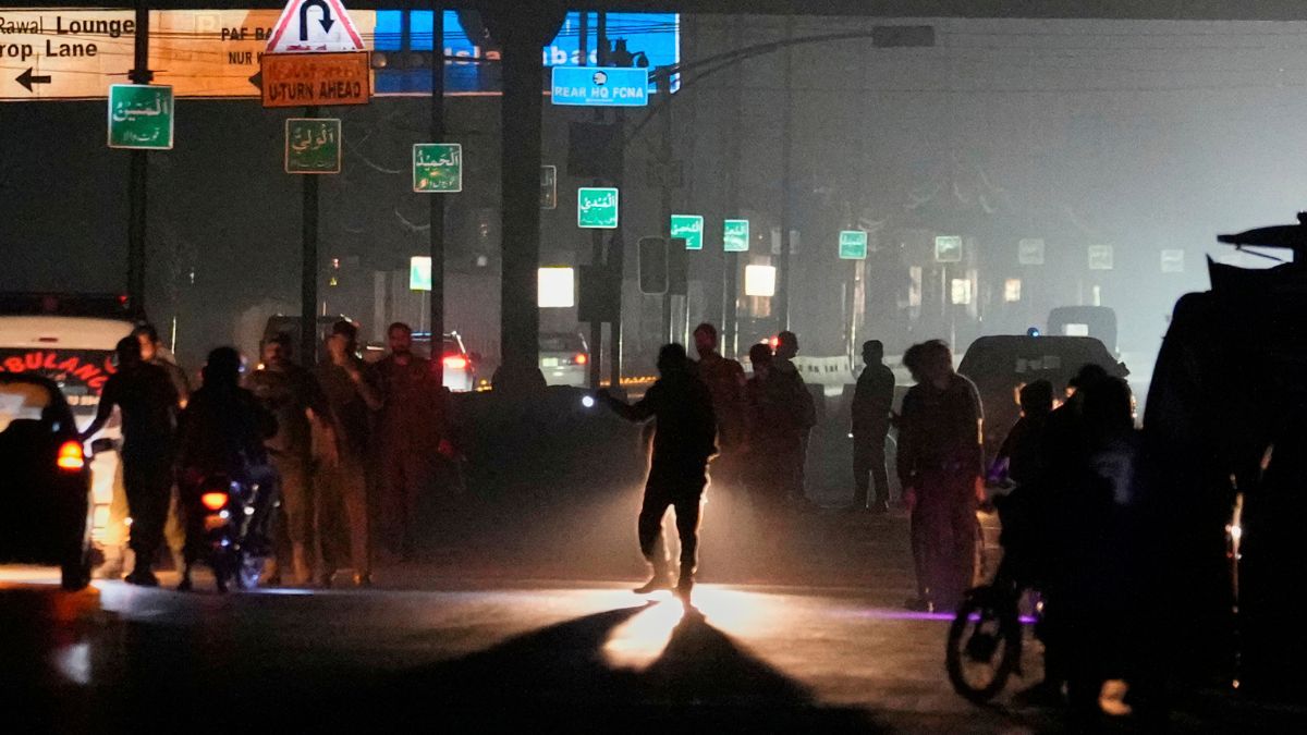 Police officers remove vehicles and people from the main entry of Nur Khan airbase following Indian missile strike on airbase, in Rawalpindi, Pakistan | AP
