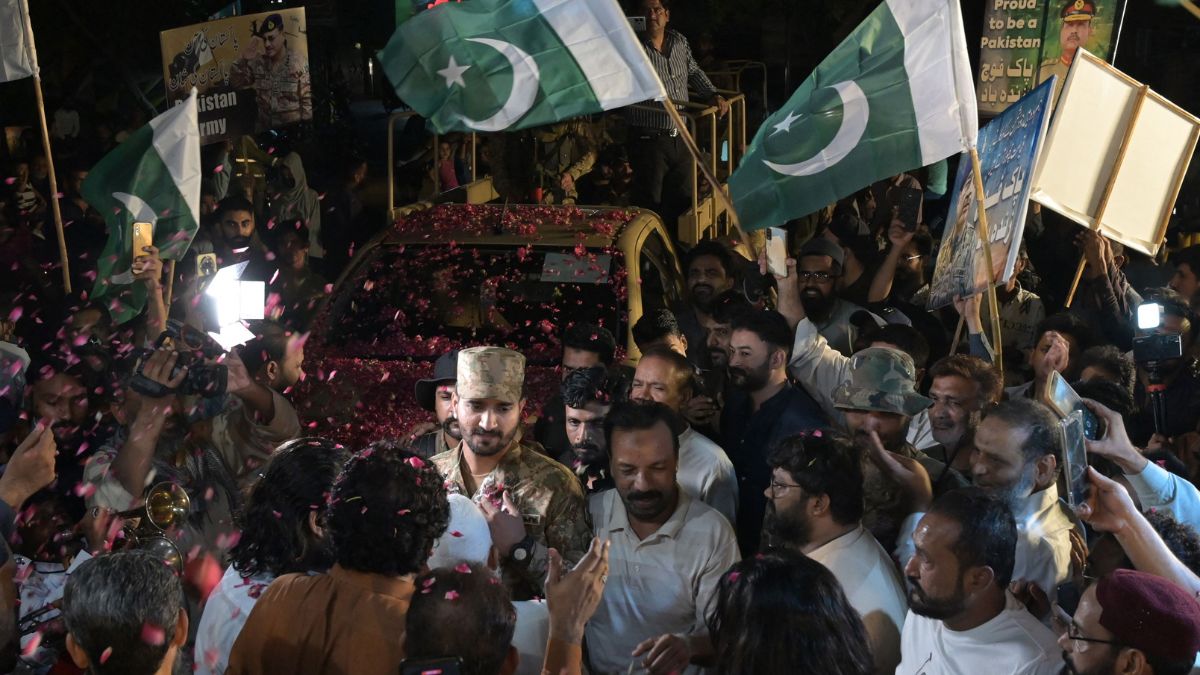 People throw rose petals at the army personnel to express solidarity with Pakistan's armed forces during a rally in the cantonment area in Hyderabad | AFP 