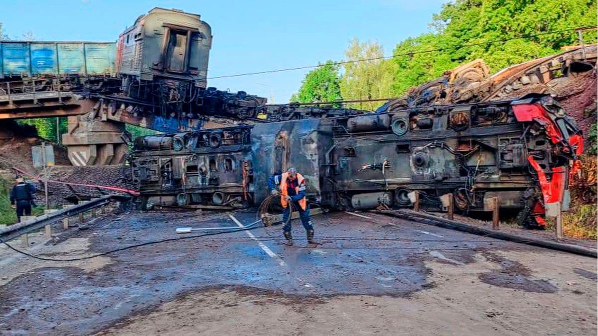 An emergency employee works at a damaged bridge after the crash of a freight train in Russia's Kursk region, which borders Ukraine (Moscow Interregional Transport Prosecutor's Office/AP)
