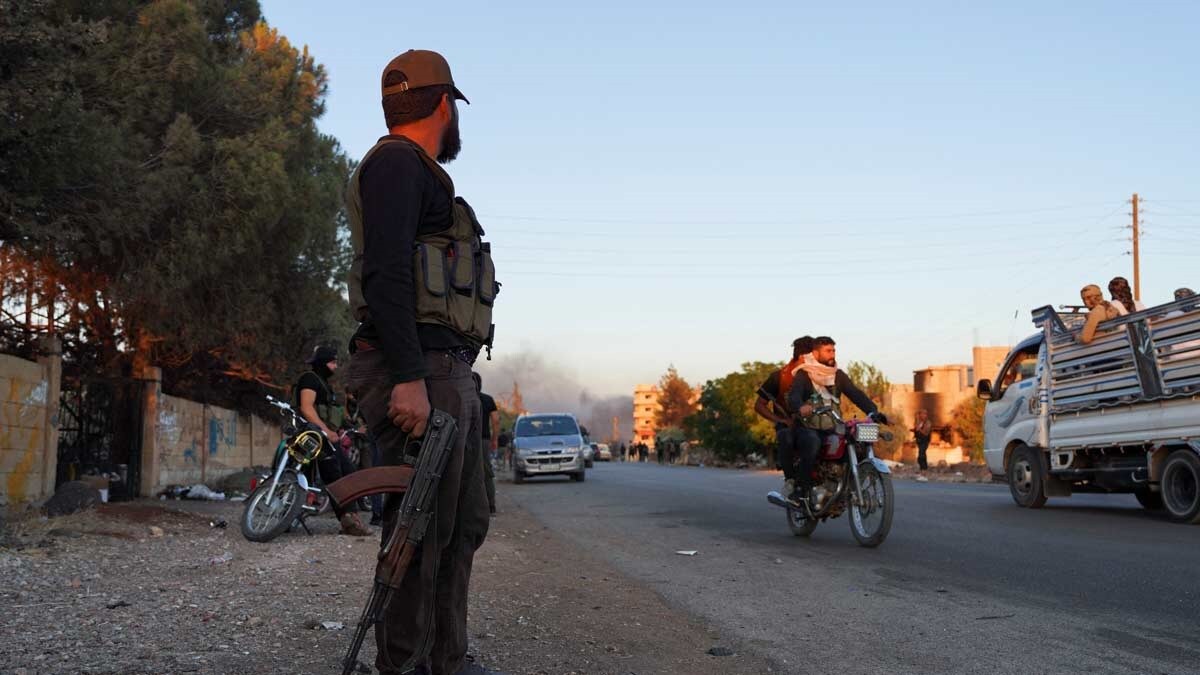 A Bedouin fighter holds a weapon as he stands along a street at Sweida governorate, Syria | Reuters