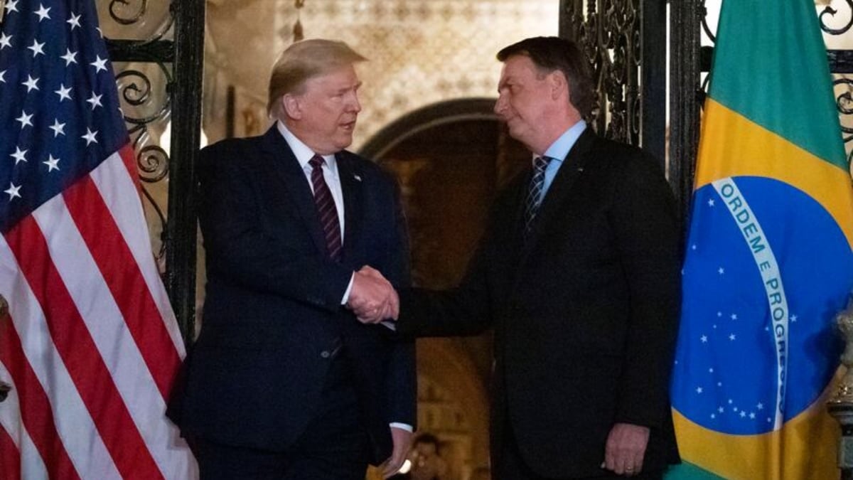 [FILE] US President Donald Trump shakes hands with Jair Bolsonaro | AP