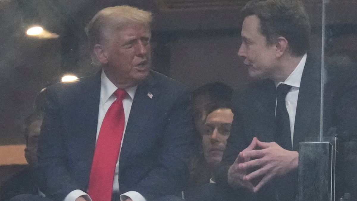 President Donald Trump and Elon musk talk during a memorial for Charlie Kirk