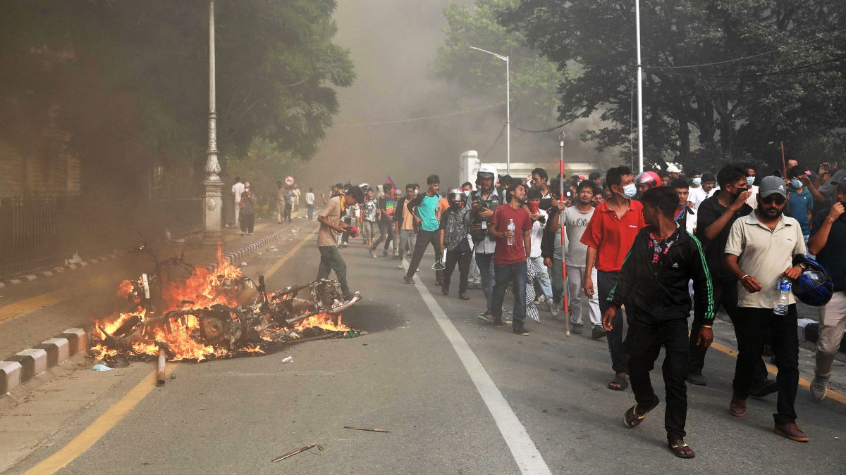 Protesters set alight a fire along a street outside the Singha Durbar, the main administrative building of the Nepal government, in Kathmandu on September 9, 2025 | AFP