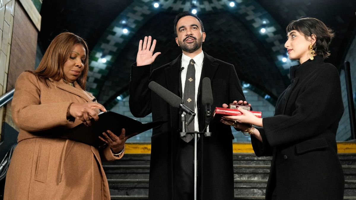 New York Attorney General Letitia James, left, administers the oath of office to mayor-elect Zohran Mamdani, center, as his wife Rama Duwaji looks on | AP