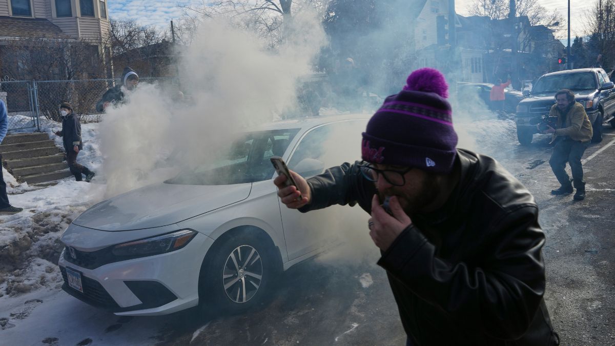 Protesters try to avoid tear gas dispersed by federal agents in Minneapolis | AP