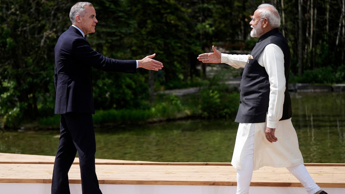 (File) Canada's Prime Minister Mark Carney, left, and India's Prime Minister Narendra Modi reach to shake hands at the G7 Summit in Kananaskis, Alberta | AP
