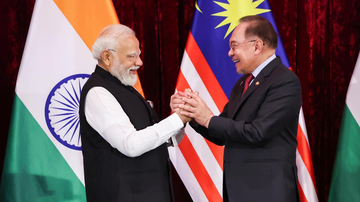 Prime Minister Narendra Modi and Malaysian Prime Minister Anwar Ibrahim hold hands during a press conference in Putrajaya | AP