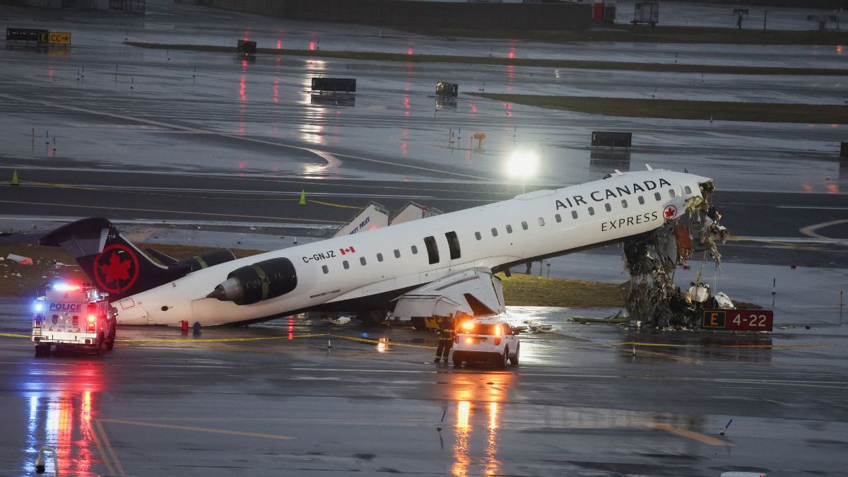 Debris hangs from a damaged Air Canada Express jet that had collided with a ground vehicle at New York's LaGuardia Airport | Reuters