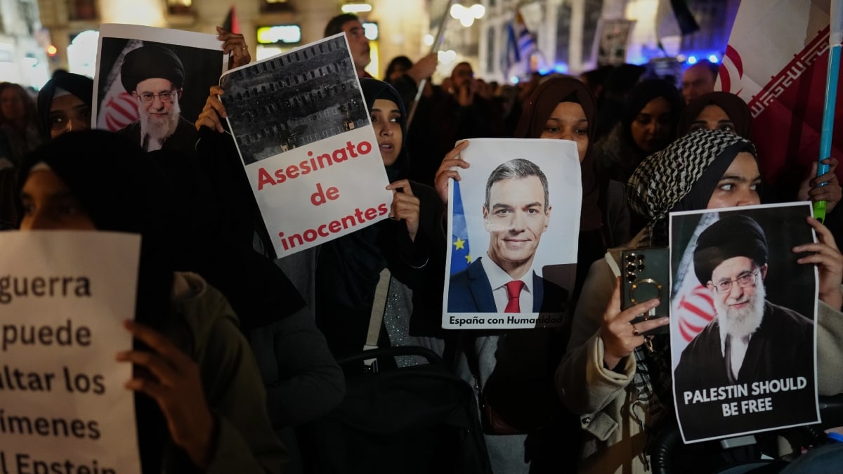 Demonstrators hold photographs of Spanish Prime Minister Pedro Sanchez during a protest against U.S. and Israeli intervention in Iran in Spain's Barcelona | AP