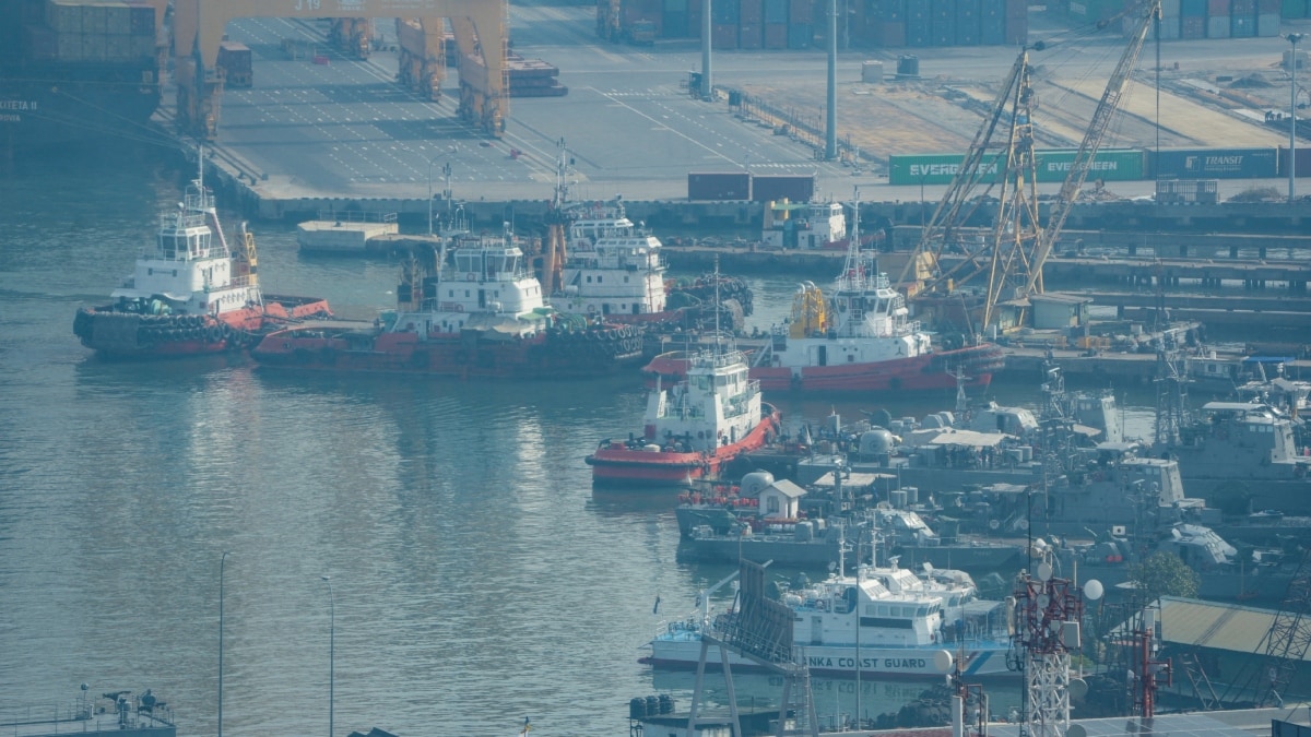 Tugboats and service vessels are seen through a window near the Western Naval Command Headquarters at the Port of Colombo | Reuters