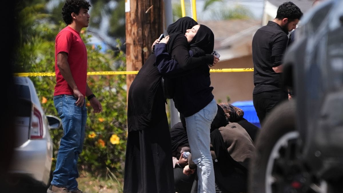 People embrace near the scene of a shooting outside the Islamic Center of San Diego on Monday | AP 
