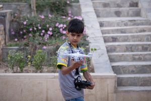 An Iranian boy tries to control a drone after participating in a training session at Pardis Technology Park in east Tehran | Getty Images