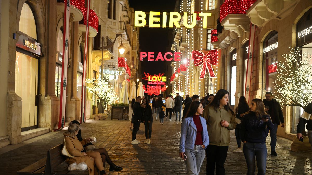 People gather near a sign which reads "Beirut" among Christmas decorations, during holiday season in downtown Beirut, Lebanon | Reuters